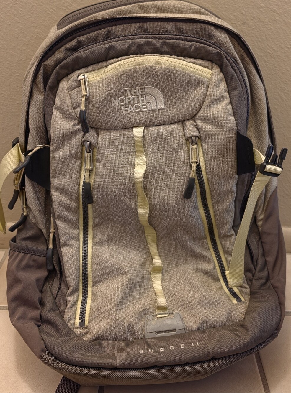 The North Face Surge II Backpack in Tan and Brown with Yellow Accents